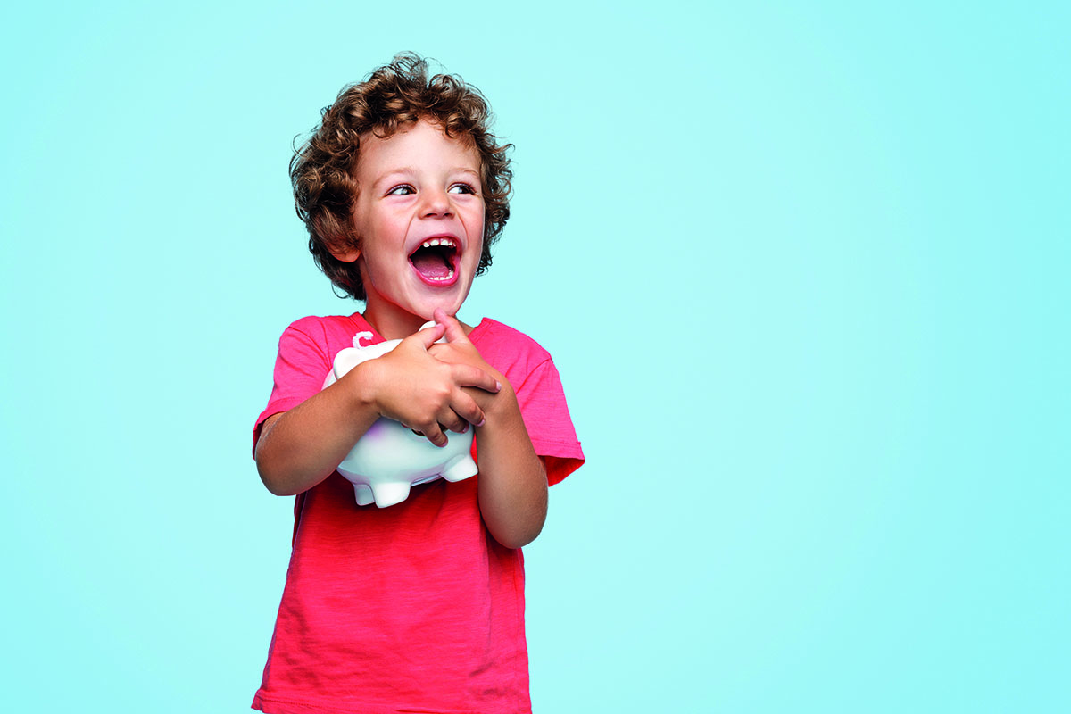 Excited kid with piggy bank